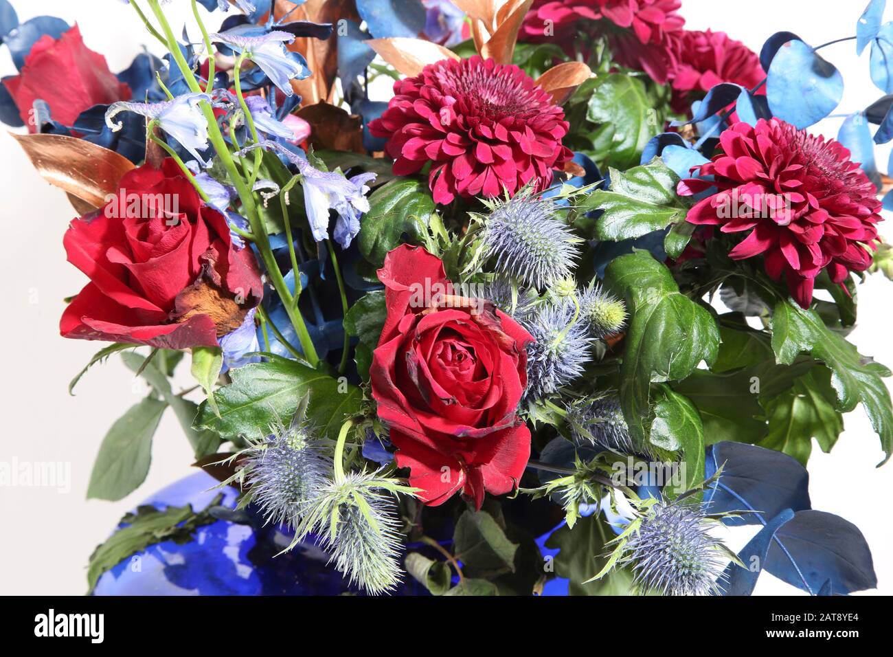 A Bouquet of Roses, Eryngium Bourgatii and Chrysanthemums in A Blue Glass Vase Stock Photo Alamy