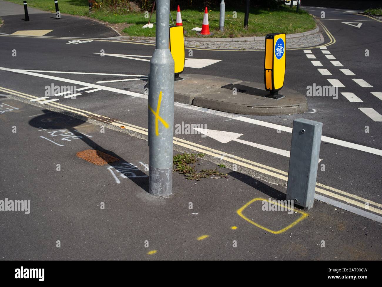 Various spray painted  road markings on new junction of Southampton cycleway with solar powered road signs. Stock Photo