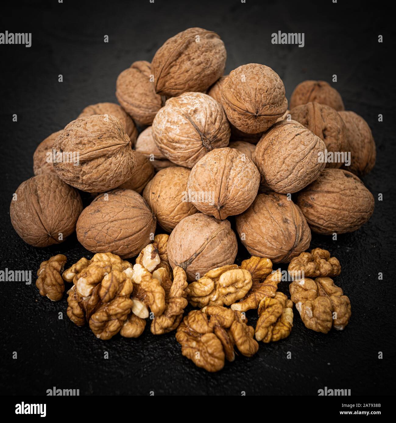 Walnut on over black slate stone background Stock Photo