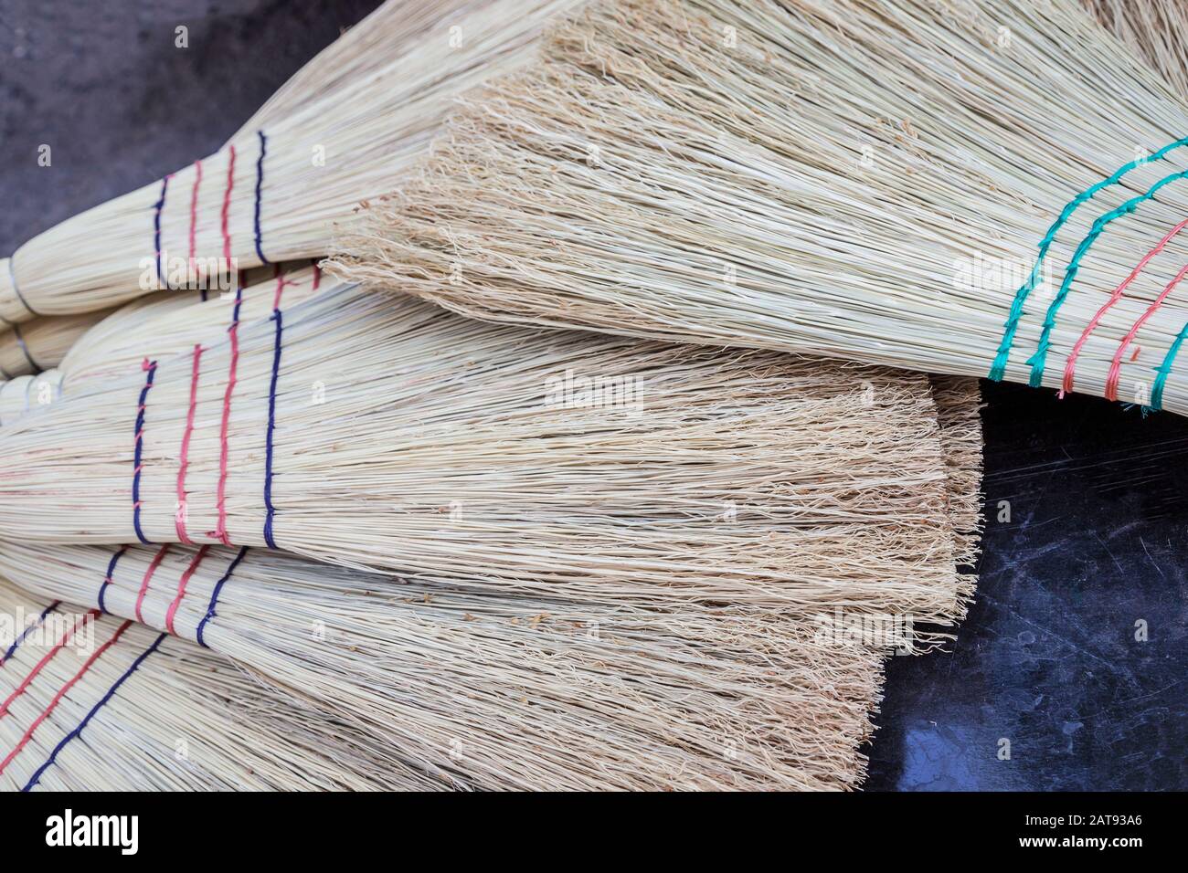 closeup pile of vintage straw brooms Stock Photo Alamy