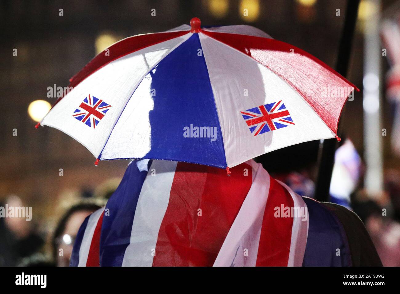 A Pro-Brexit supporter shelters from the rain in Parliament Square, London, ahead of the UK leaving the European Union at 11pm on Friday. Stock Photo