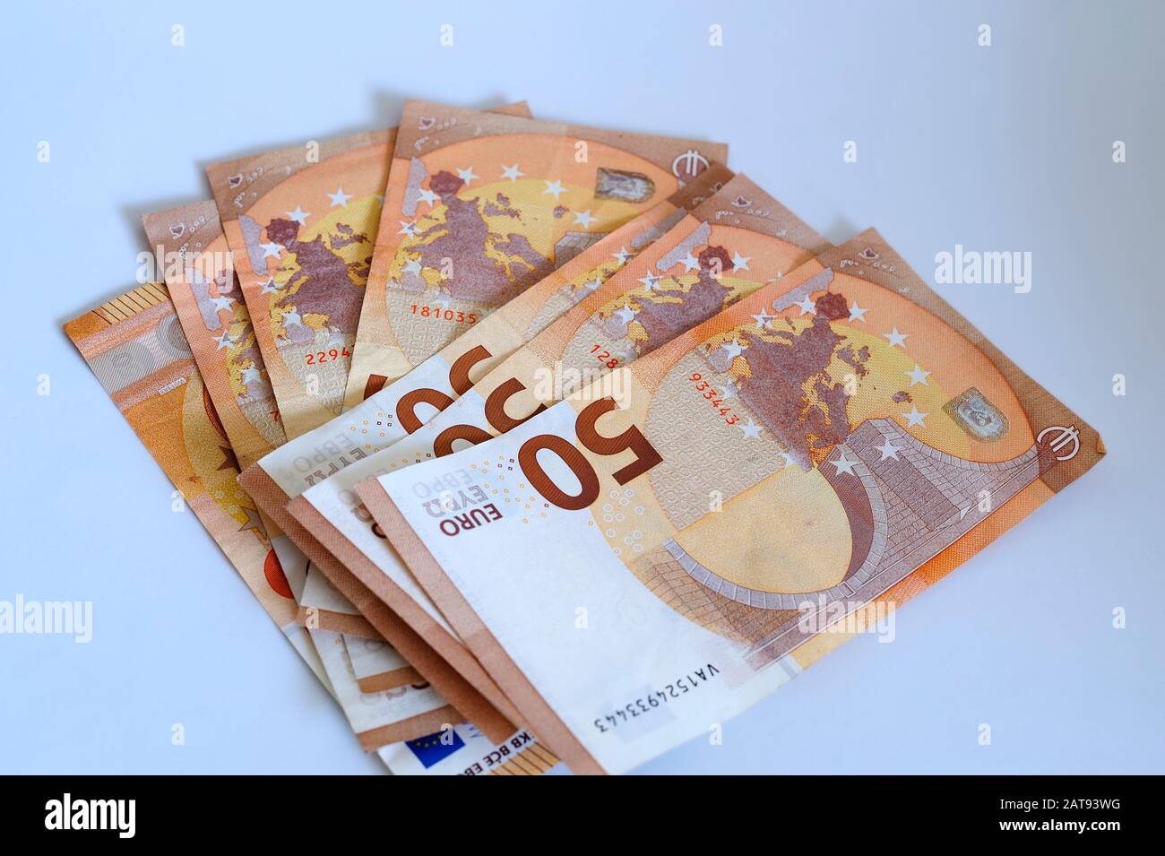 Some fifty euros bank notes on white surface. Stock Photo