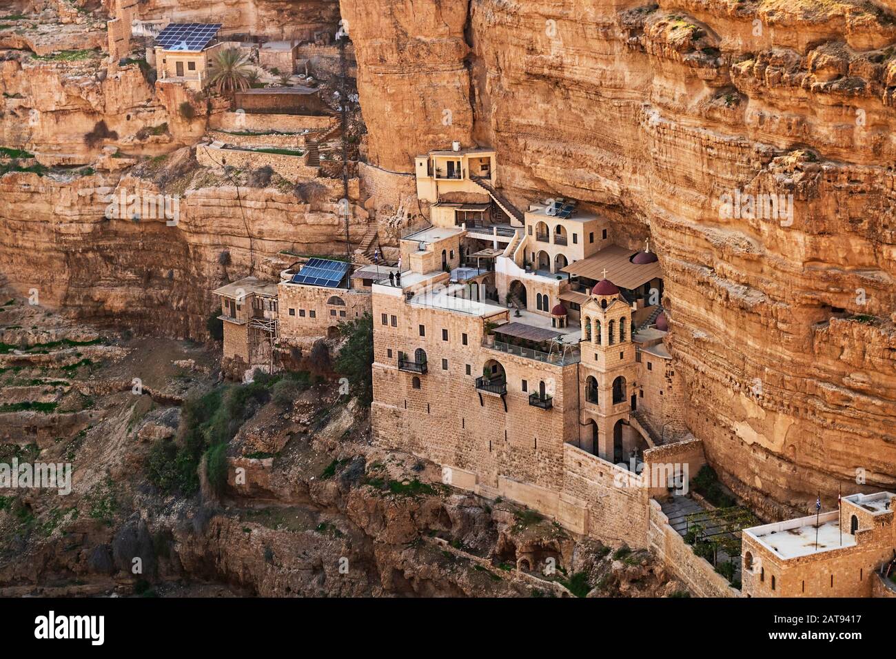 western side of the ancient saint george's monastery built into the limestone cliffs and caves of wadi qelt nahal prat near jericho in the west bank Stock Photo