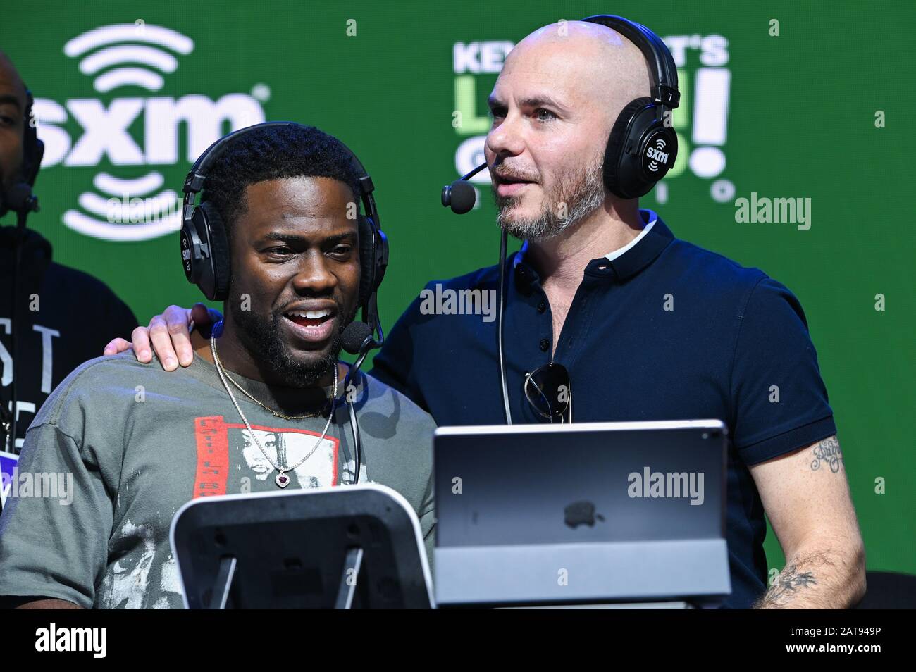Miami, USA. 31st Jan, 2020. Kevin Hart and Pitt Bull record the radio show Laugh Out Loud Radio at SiriusXM on radio row for Super Bowl LIV held at the Miami Beach Convention Center in Miami, Florida on Jan. 31, 2020. (Photo by Anthony Behar/Sipa USA) Credit: Sipa USA/Alamy Live News Stock Photo