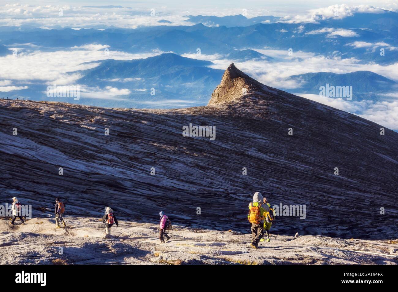 Hikers at the top of Mount Kinabalu at sunrise in Sabath, Borneo, East Malaysia. Stock Photo
