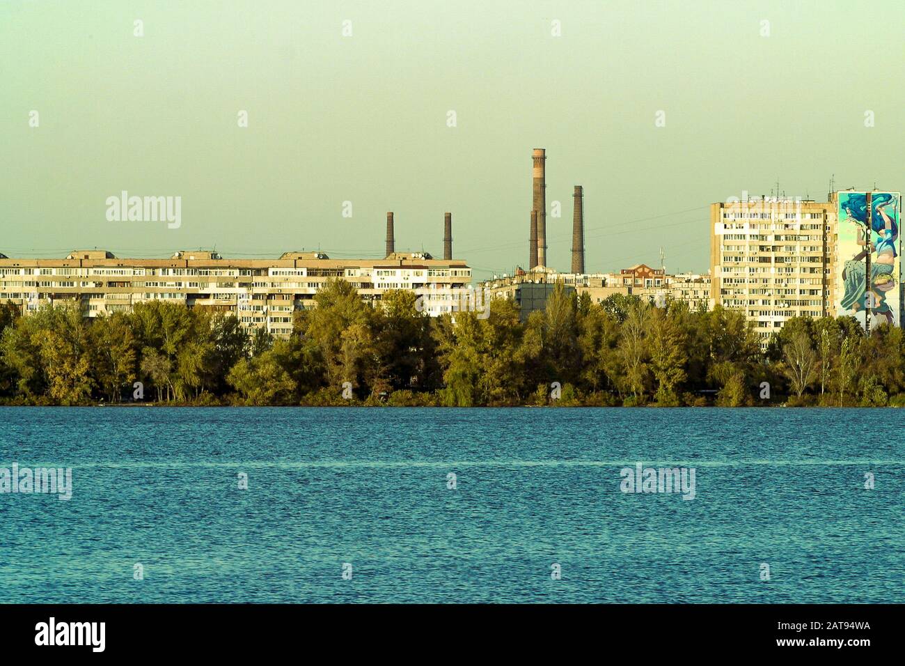 The left side of Dnipro city, Ukraine. Panoramic view of the Dnipro river. Cityscape Housing estate Sunny Mural artwork is painted by Artist Olexander Brytcev Stock Photo