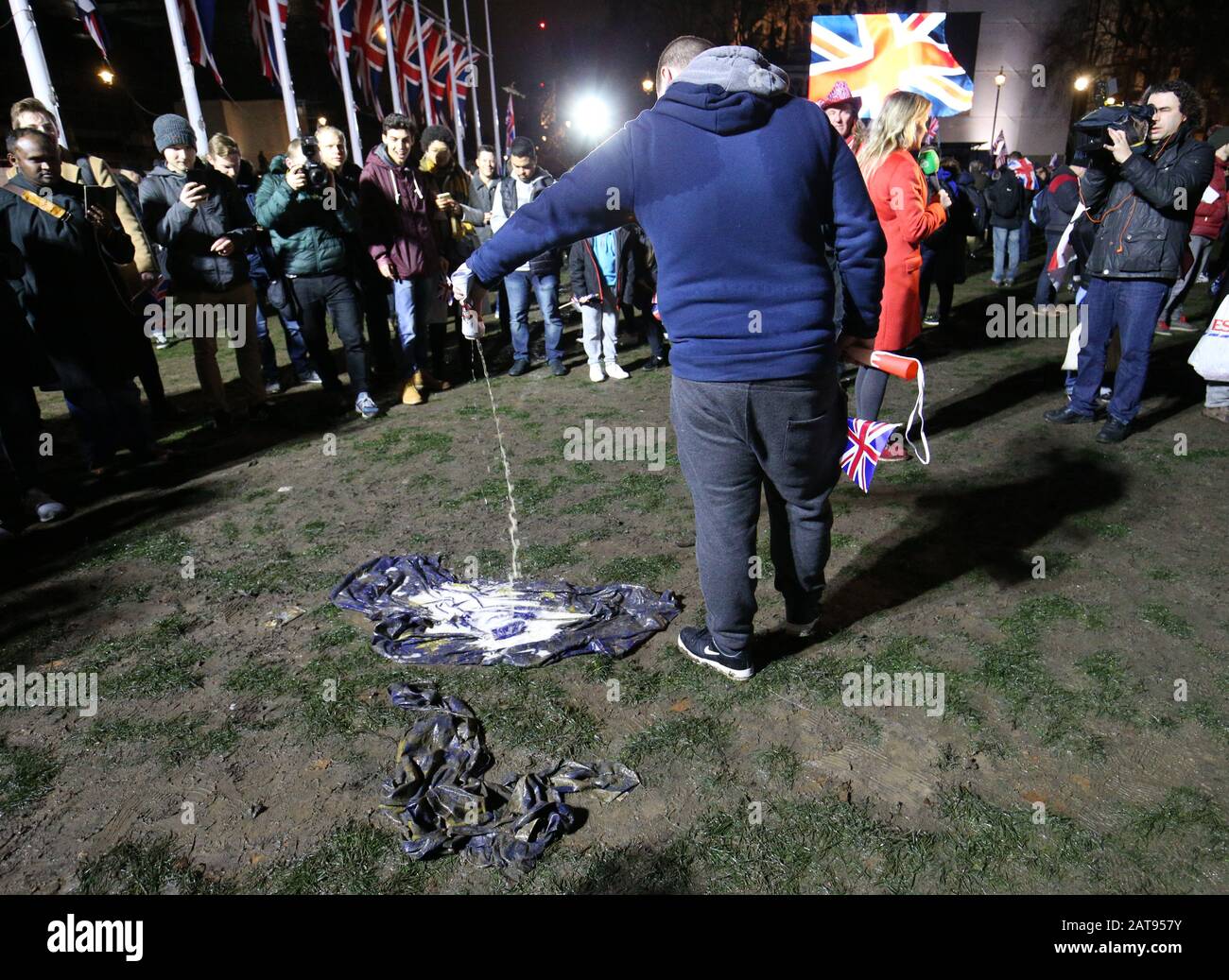 A pro-Brexit supporter pours beer onto an EU flag in Parliament Square, London, ahead of the UK leaving the European Union at 11pm on Friday. Stock Photo