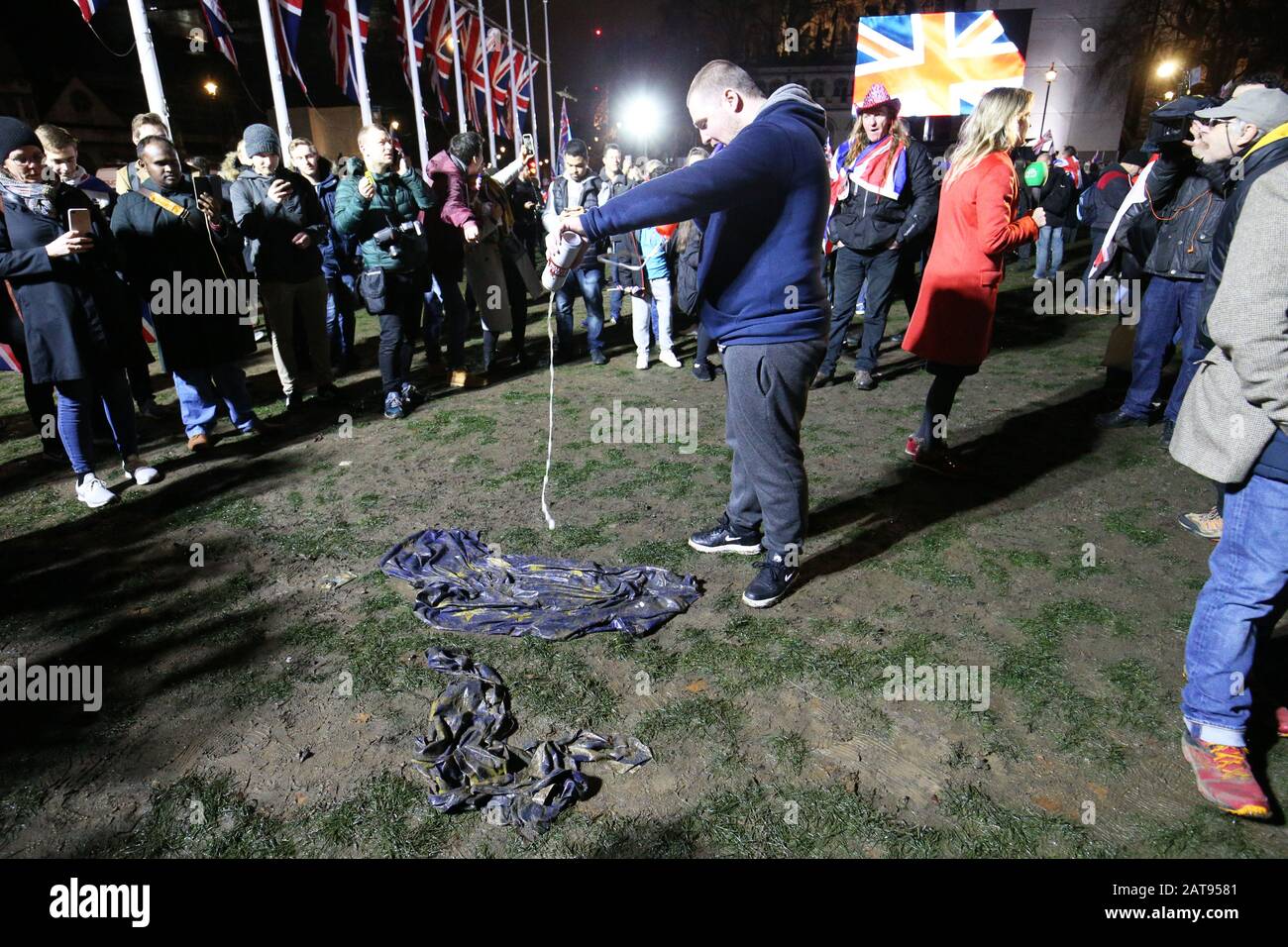 A pro-Brexit supporter pours beer onto an EU flag in Parliament Square, London, ahead of the UK leaving the European Union at 11pm on Friday. Stock Photo