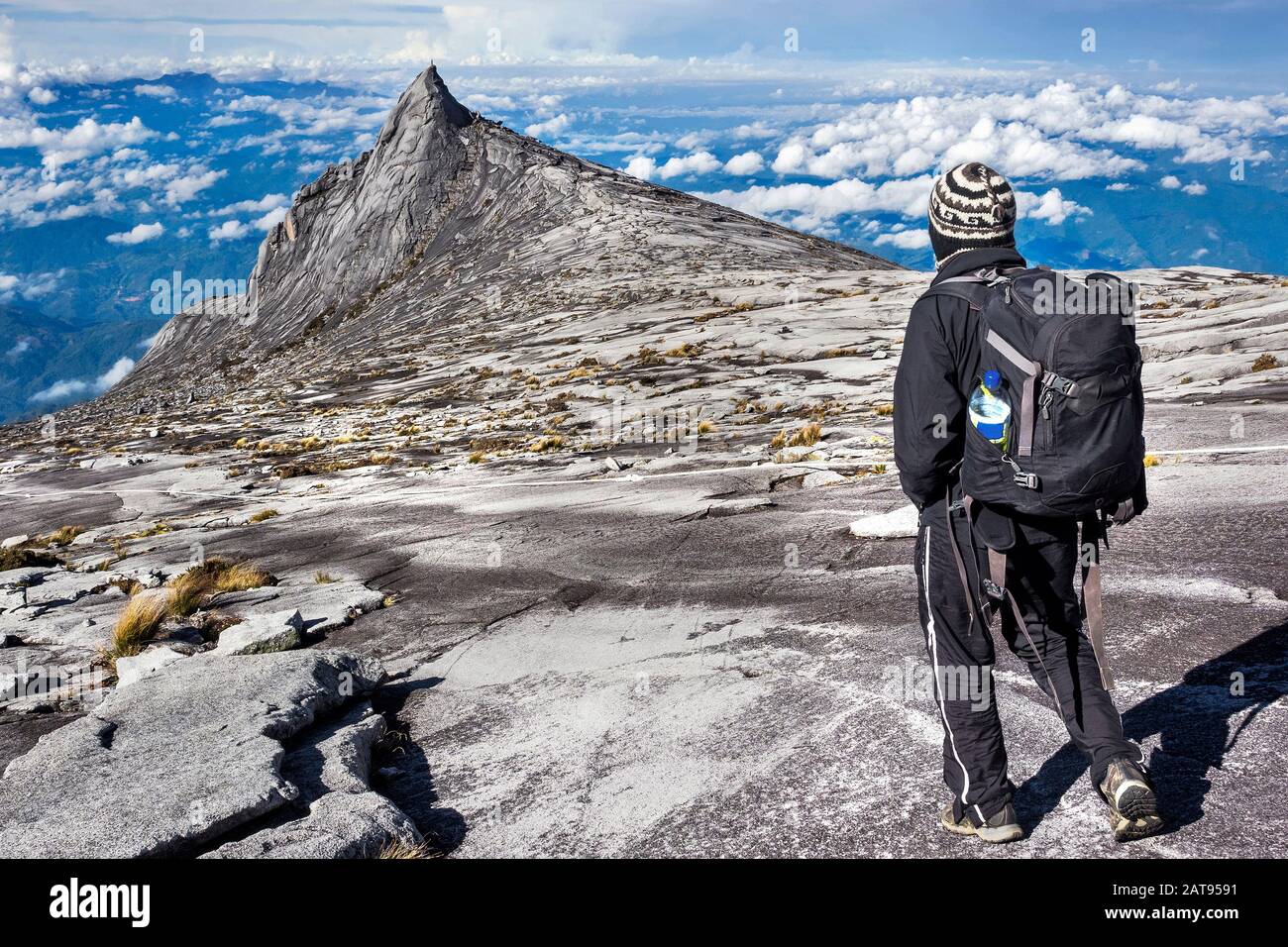Hiker at the top of Mount Kinabalu in Sabah, Borneo, East Malaysia. Stock Photo