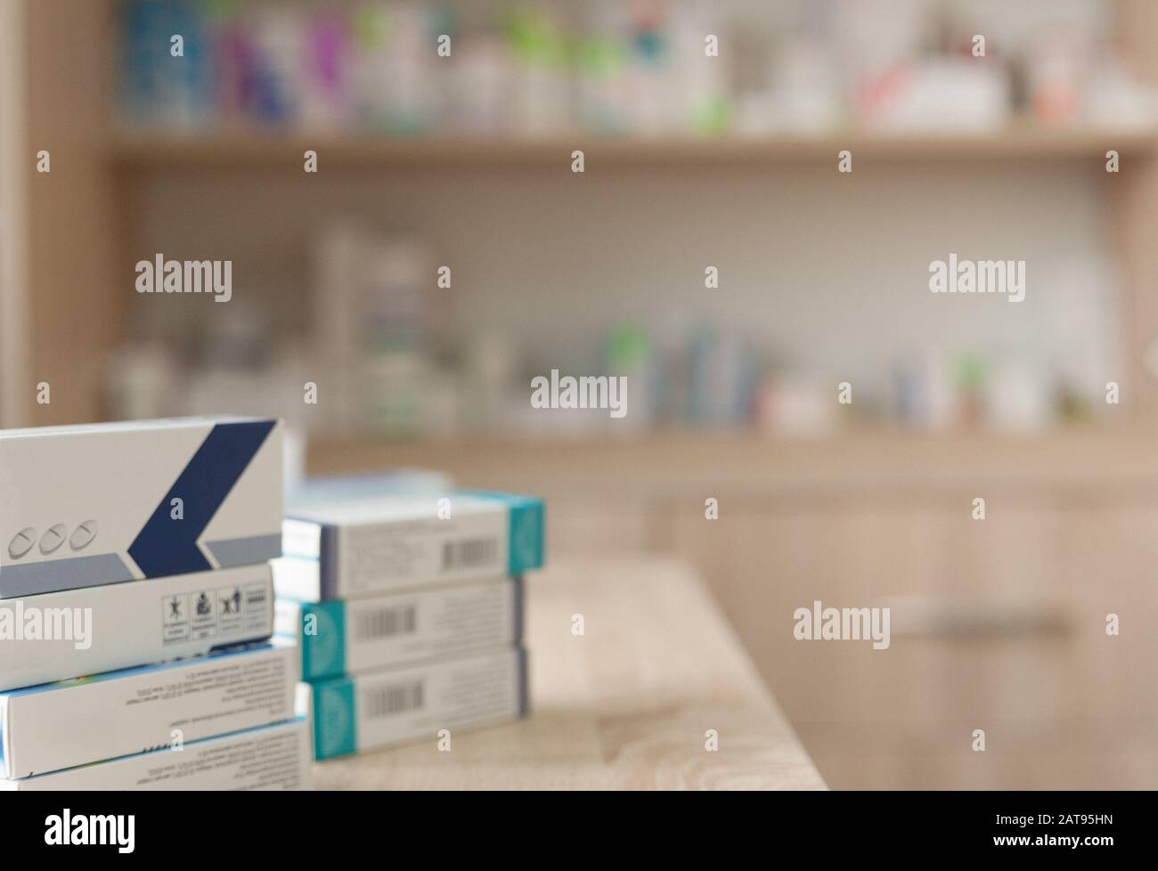 packaging of drugs in a pharmacy on the background of shelves with medicines Stock Photo