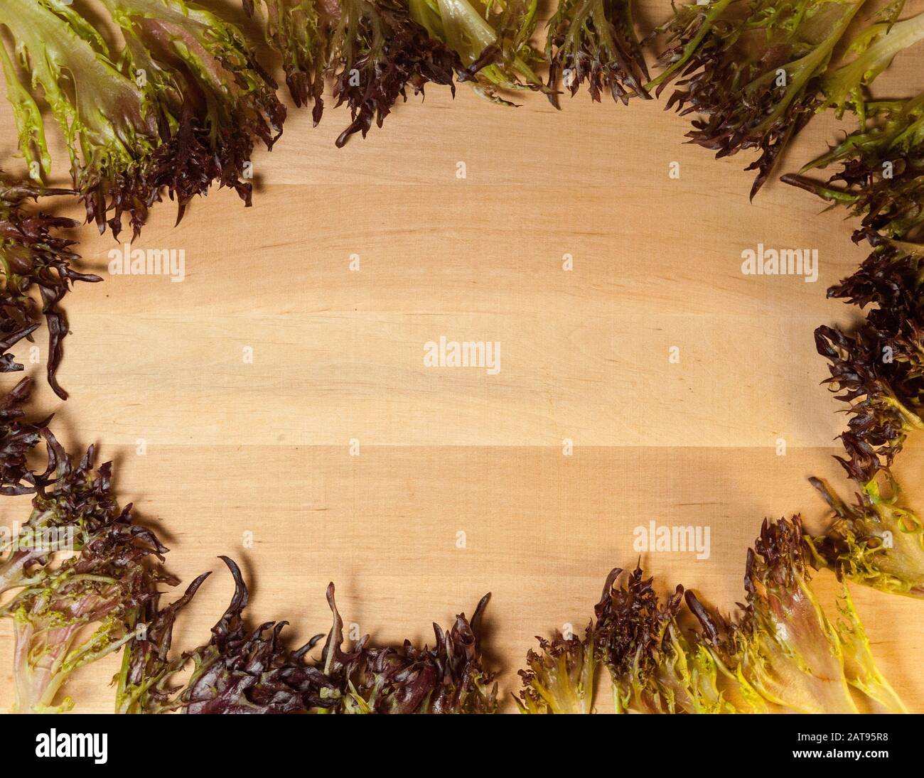 Rosso salad in the form of a frame on a wooden board Stock Photo