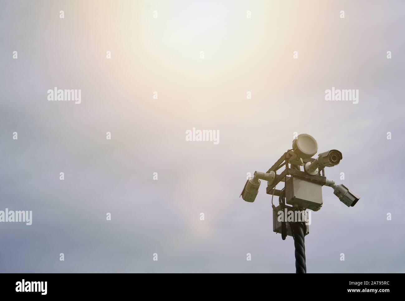 CCTV cameras are directed in different directions in a public place against the sky Stock Photo