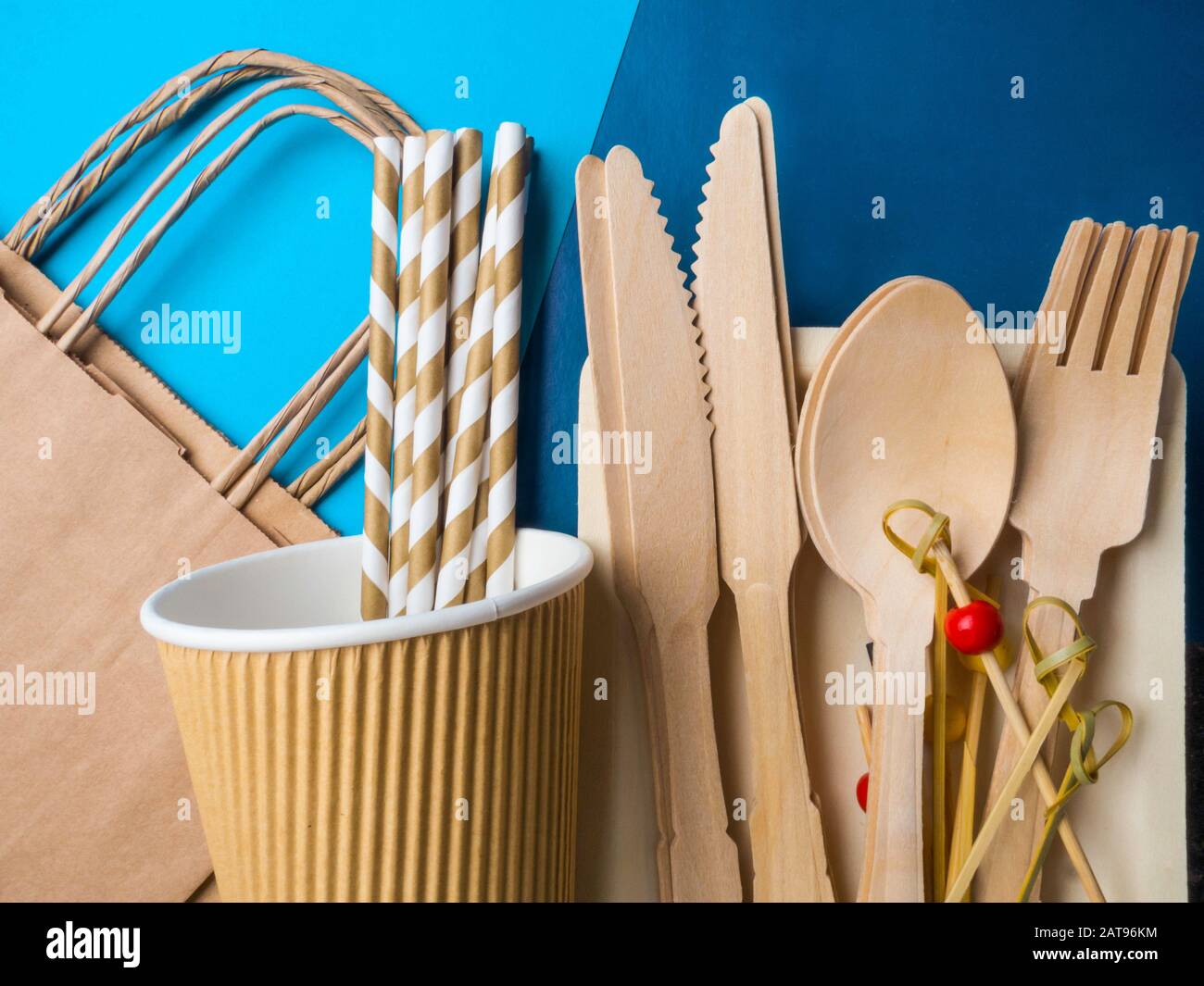 Disposable wooden cutlery and paper bag on trendy blue color background,  cutlery, recycling and eco friendly concept, plastic-free alternatives zero  Stock Photo - Alamy