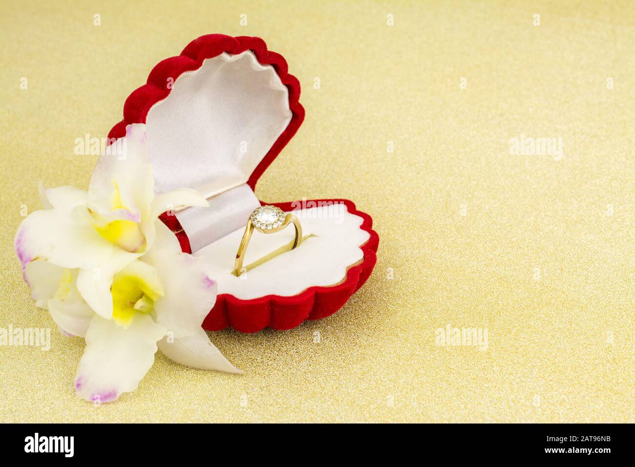 gold ring in red box on gold background Stock Photo - Alamy