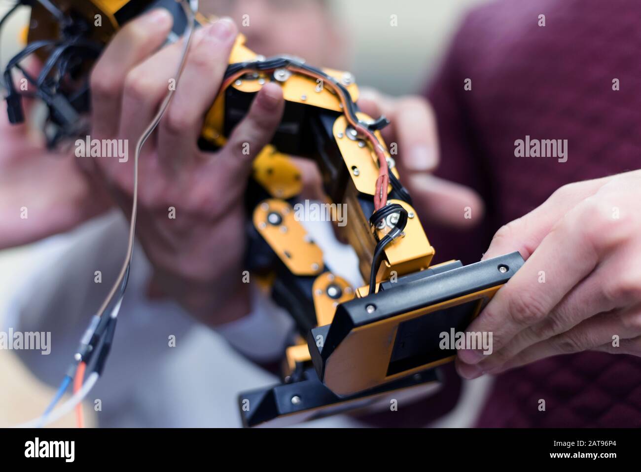 Group of young engineers working on robotics project. Scientist ...