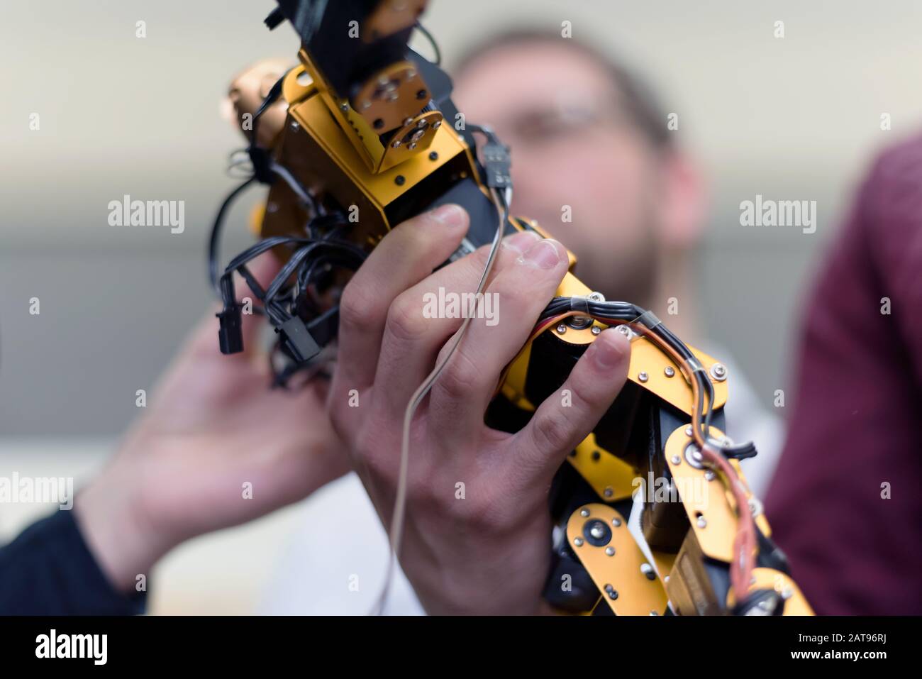 Group of young engineers working on robotics project. Scientist ...