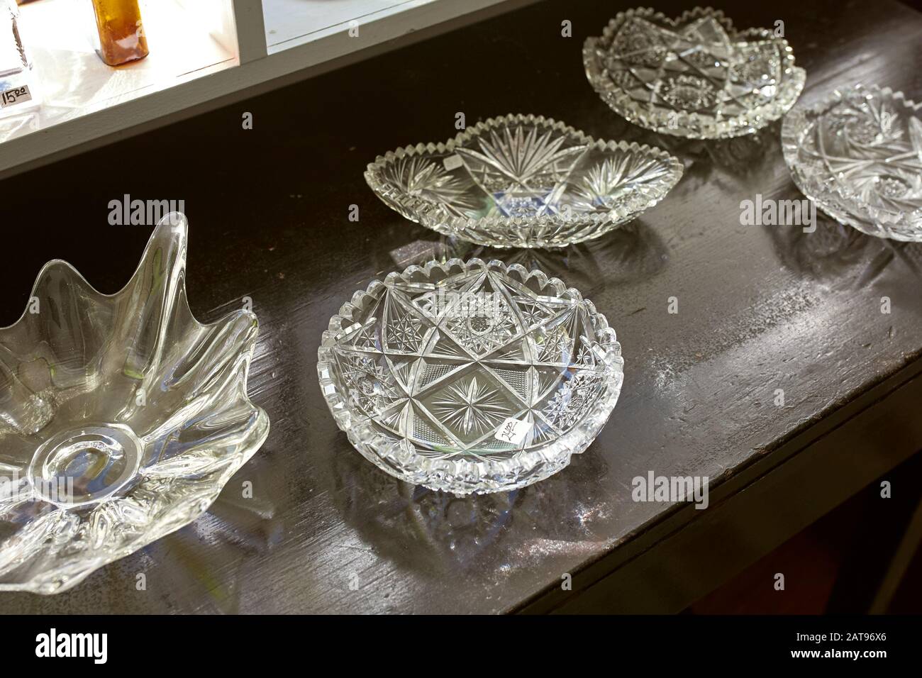 Vintage crystal glass bowls and dishes on a wooden table at an antique  store. Maine, USA Stock Photo - Alamy