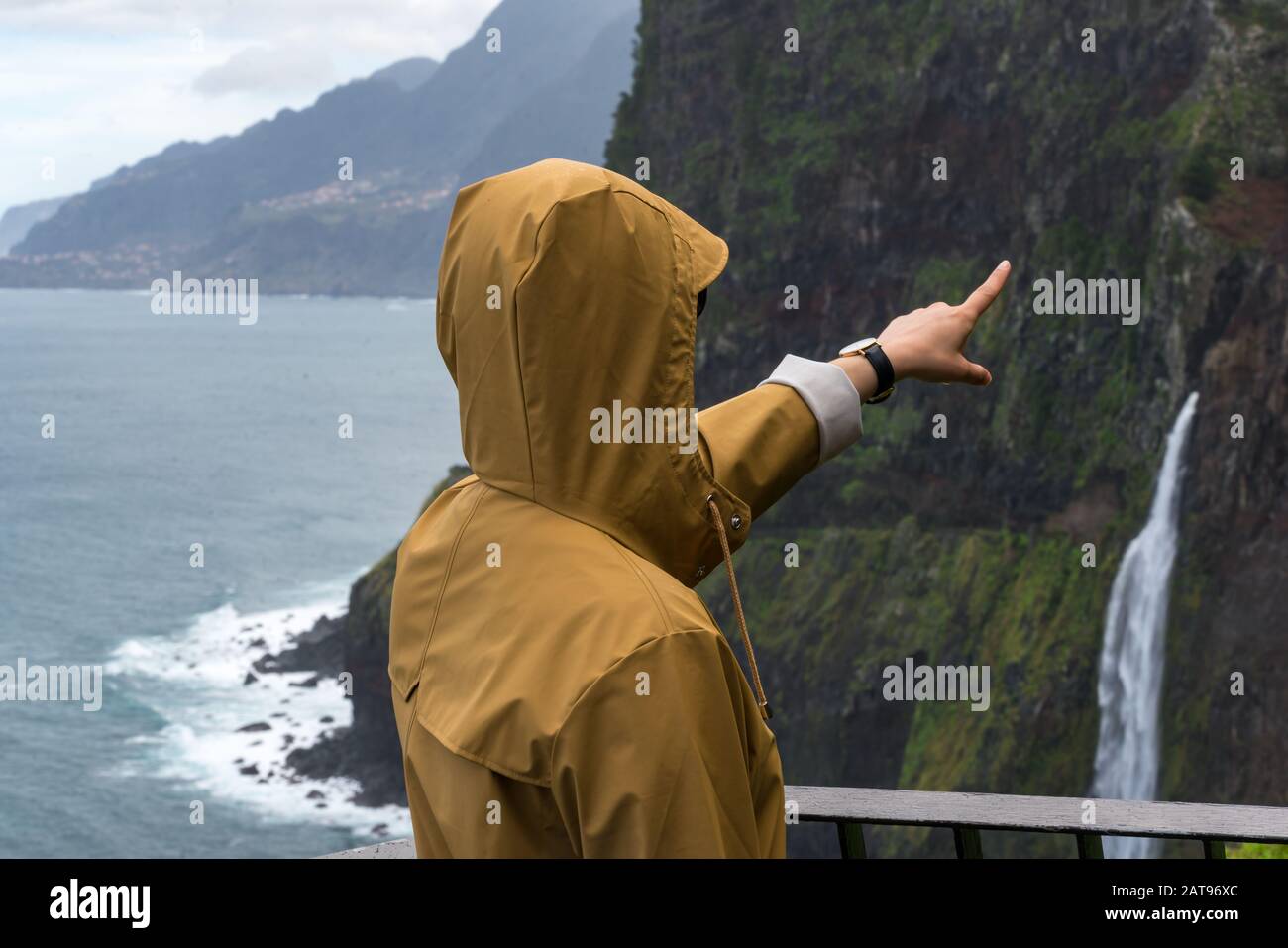 Woman looking at Bridal Veil Falls veu da noiva in Madeira, Portugal