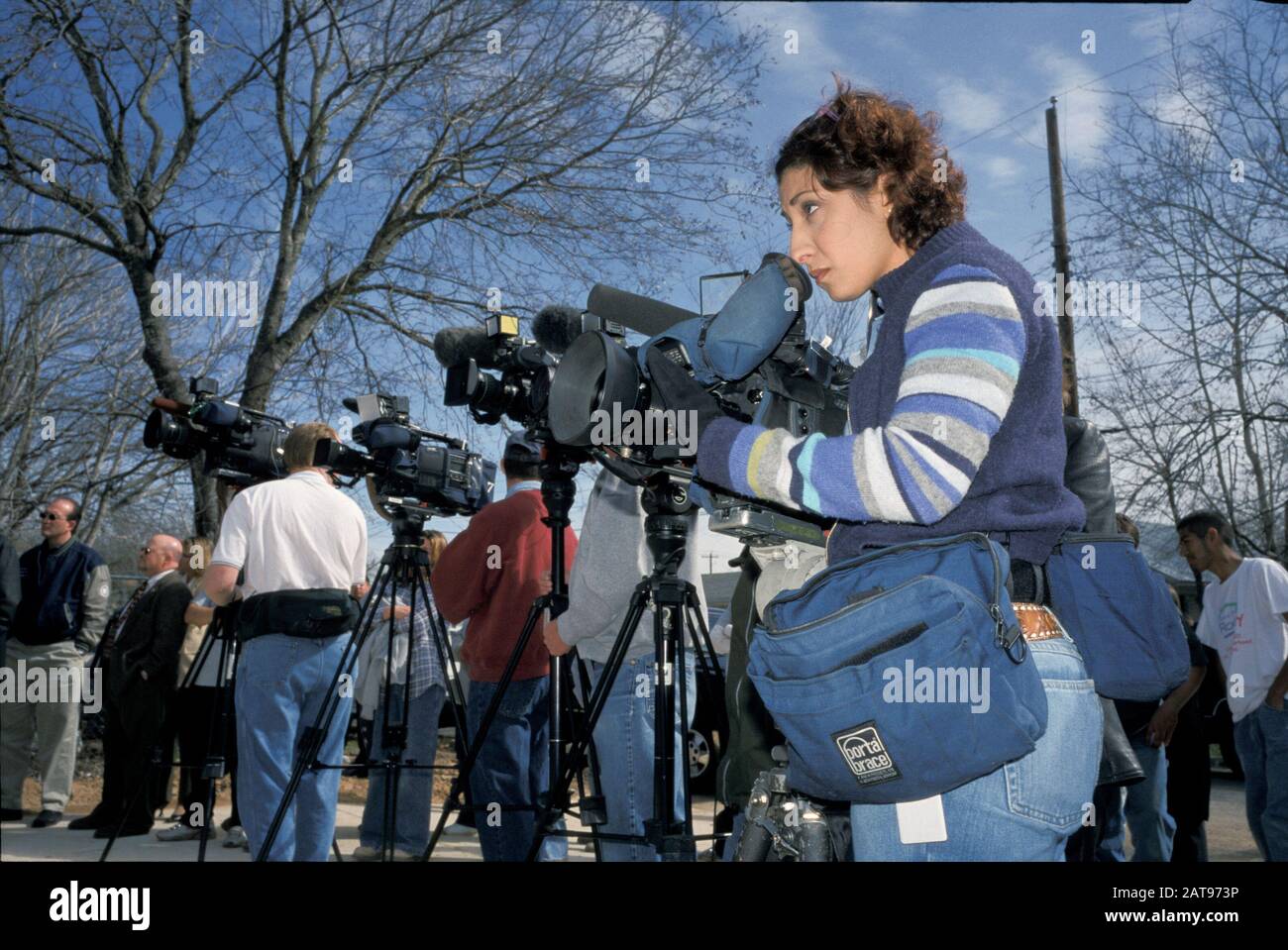 Austin, Texas: Television news camerawoman and other members of the Capitol press corps cover Texas Gov. Rick Perry's press conference on insurance. February 2002  ©Bob Daemmrich Stock Photo