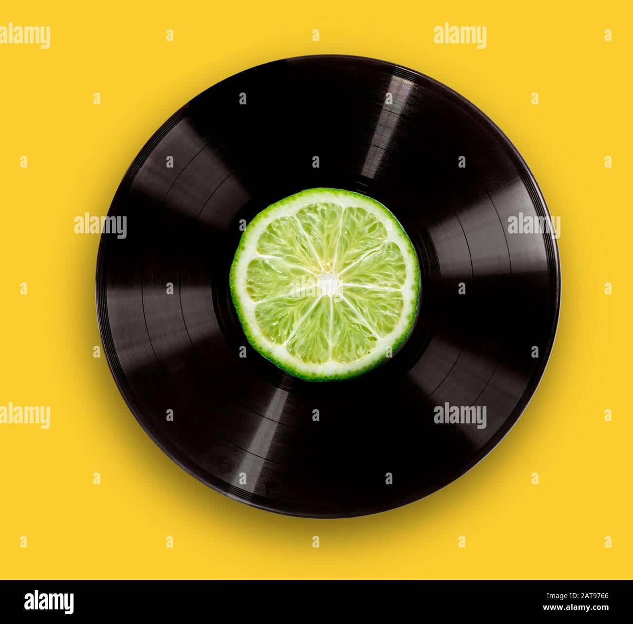 vinyl record on a bright yellow background. The concept of fresh music ...