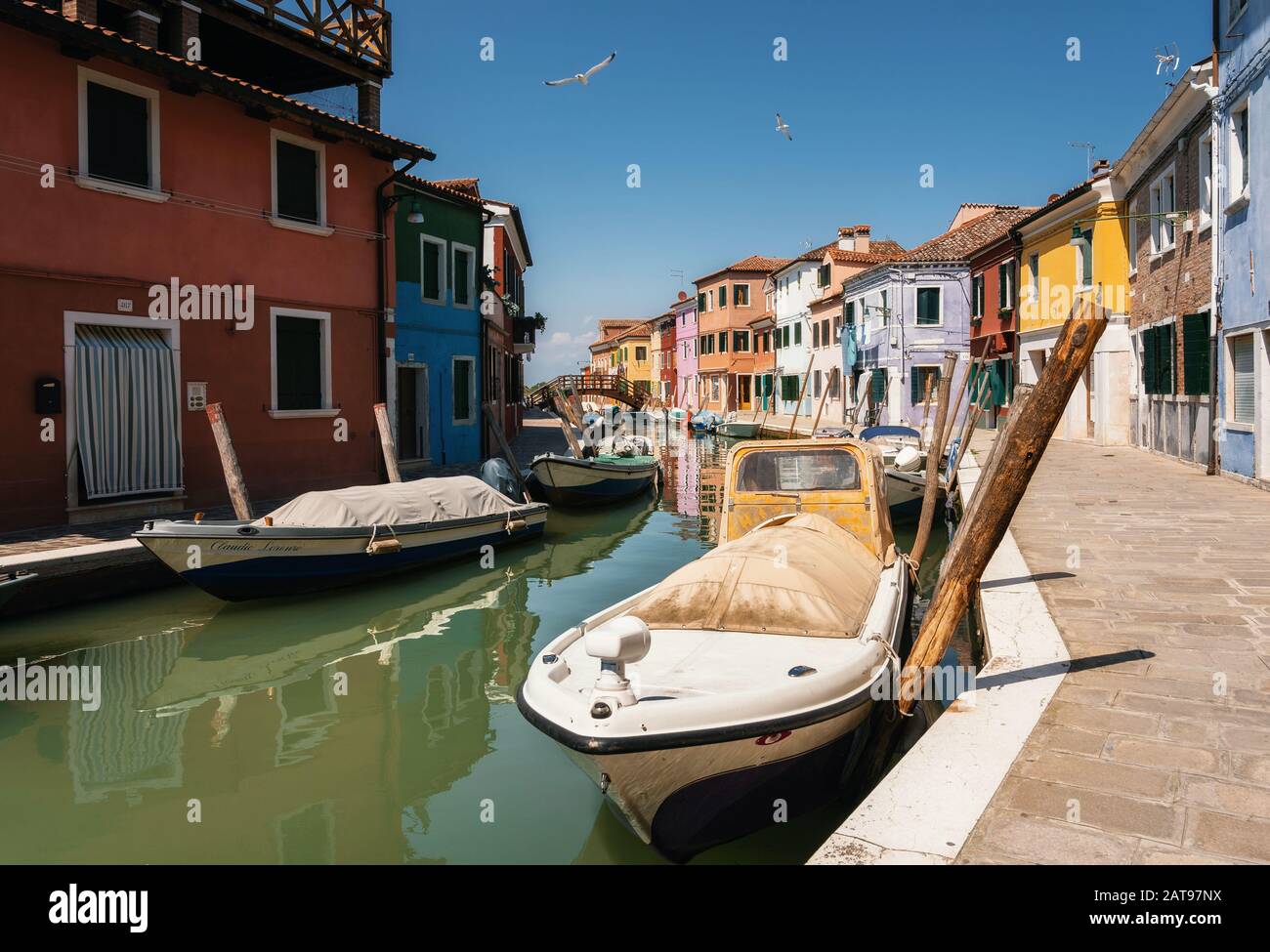 Colorful houses in Burano along canal and boats, Venice, Italy Stock ...