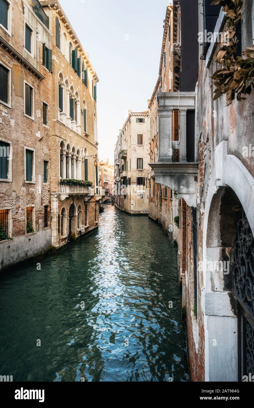 Colorful houses along narrow canal waters of Venice Italy Stock Photo ...