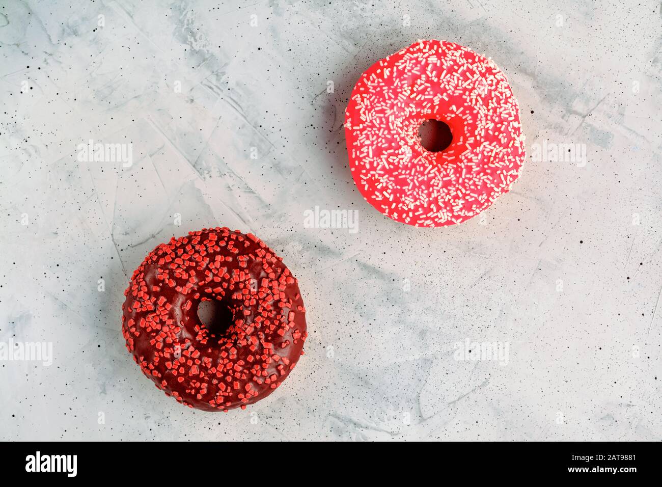 Delicious chocolate donuts on a gray concrete surface. Stock Photo