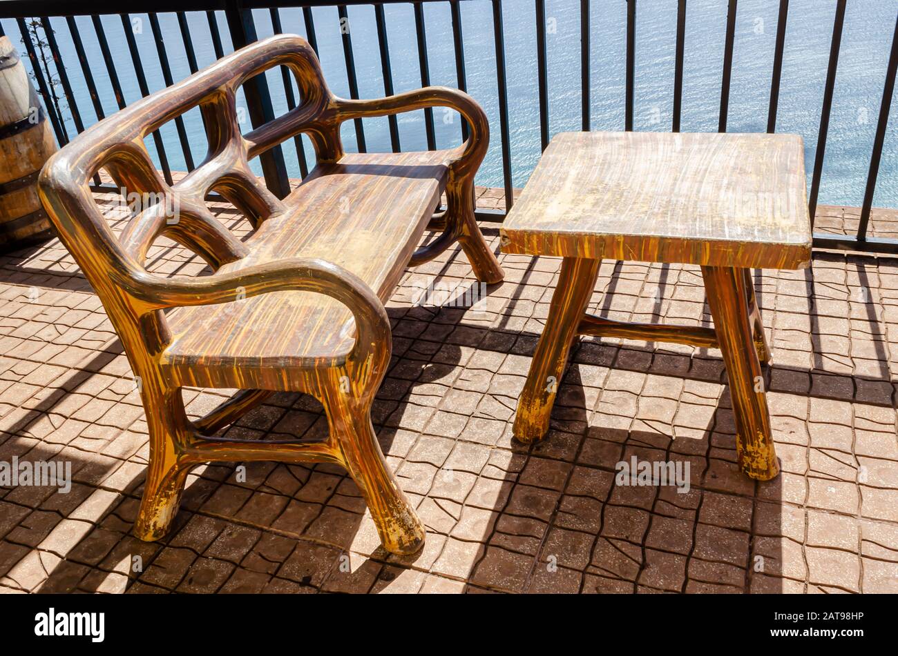 Top View Of Concrete Table And Chair On Sunny Porch Stock Photo