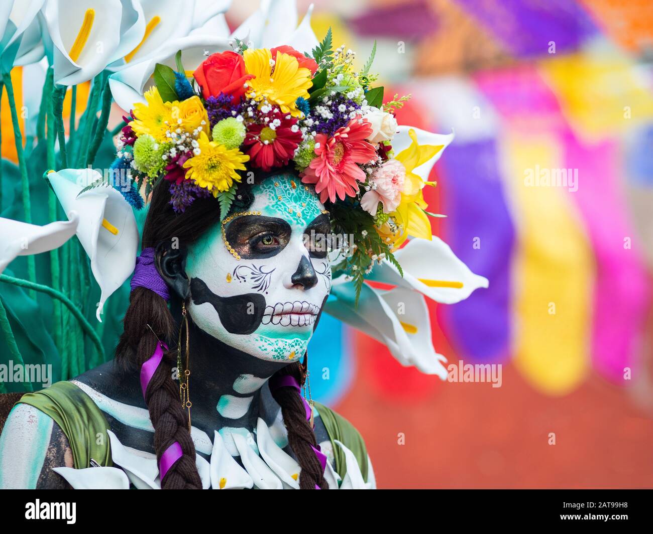 Portrait of a woman with beautiful Day of the Dead themed costumes and skull makeup on the streets of Guanajuato, Mexico. Stock Photo