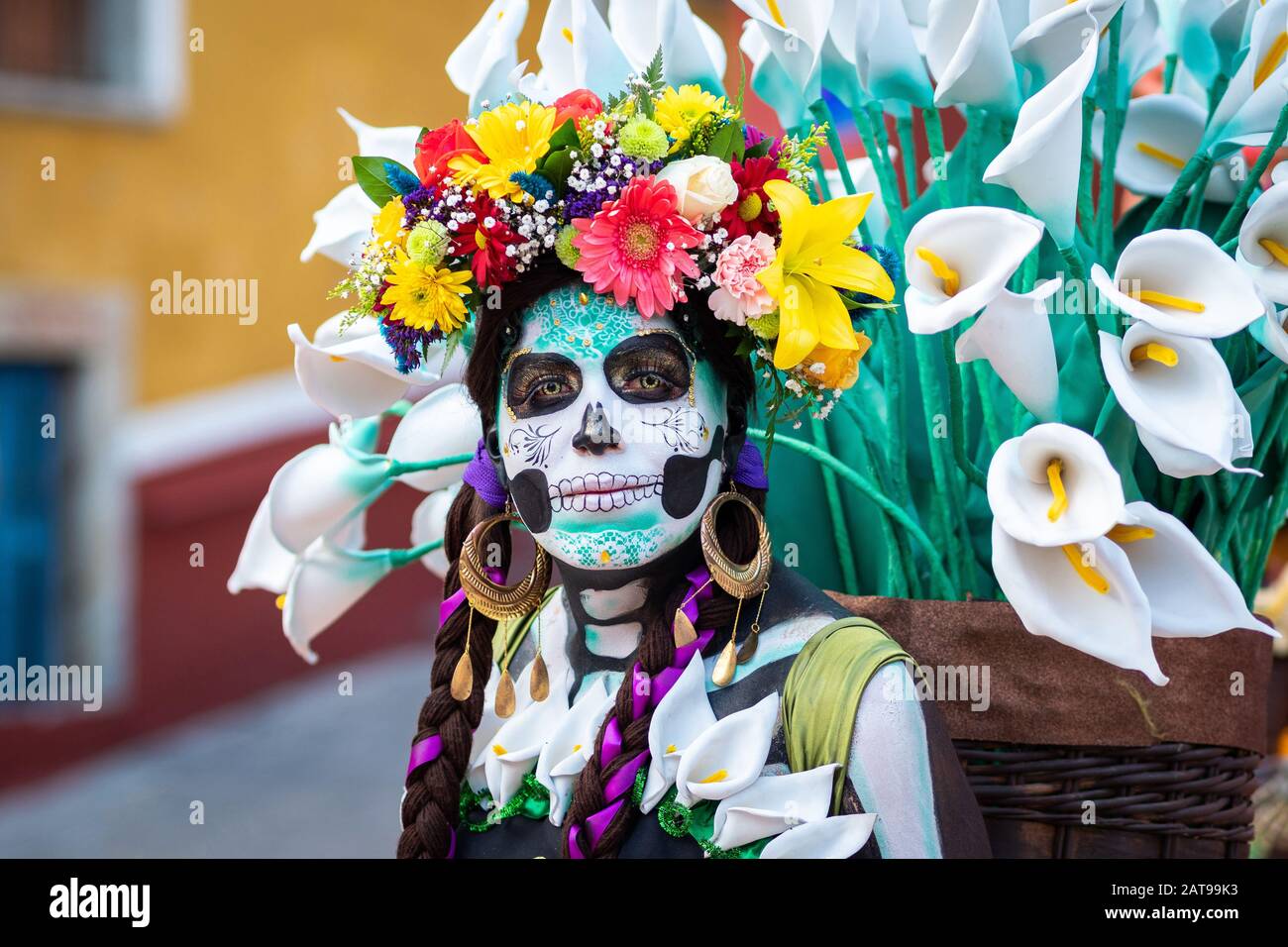 Portrait of a woman with beautiful Day of the Dead themed costumes and skull makeup on the streets of Guanajuato, Mexico. Stock Photo