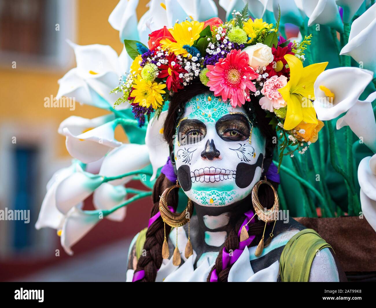 Portrait of a woman with beautiful Day of the Dead themed costumes and skull makeup on the streets of Guanajuato, Mexico. Stock Photo