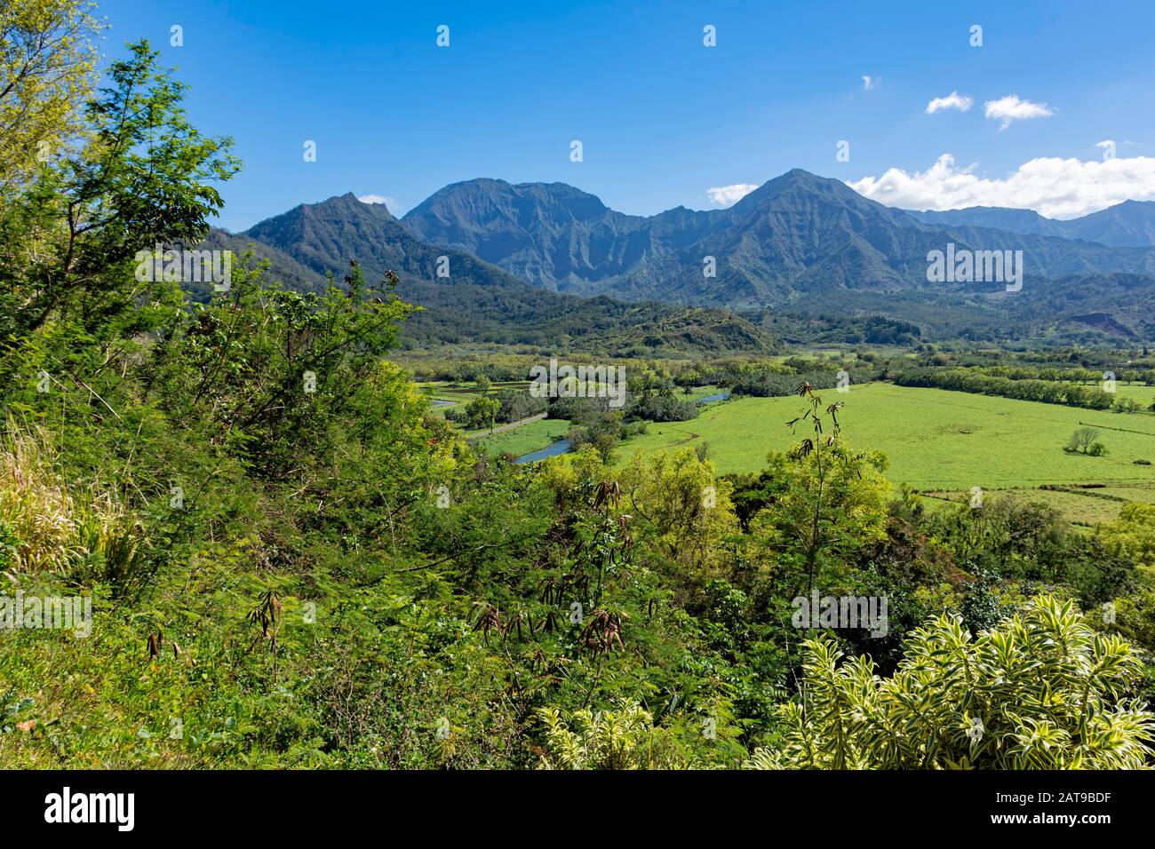 View overlooking the Na Pali coast and fields in the Hanalei River valley Princeville Kauai Hawaii USA in the afternoon sun Stock Photo