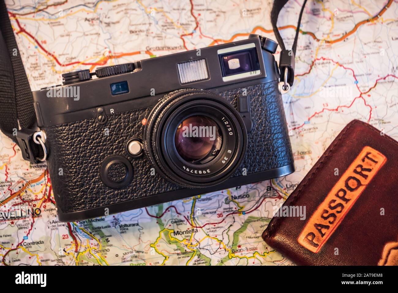 Travel Photography Concept - Photo Camera, Passport and Map on a Dark Wood Background - Vintage Look Stock Photo