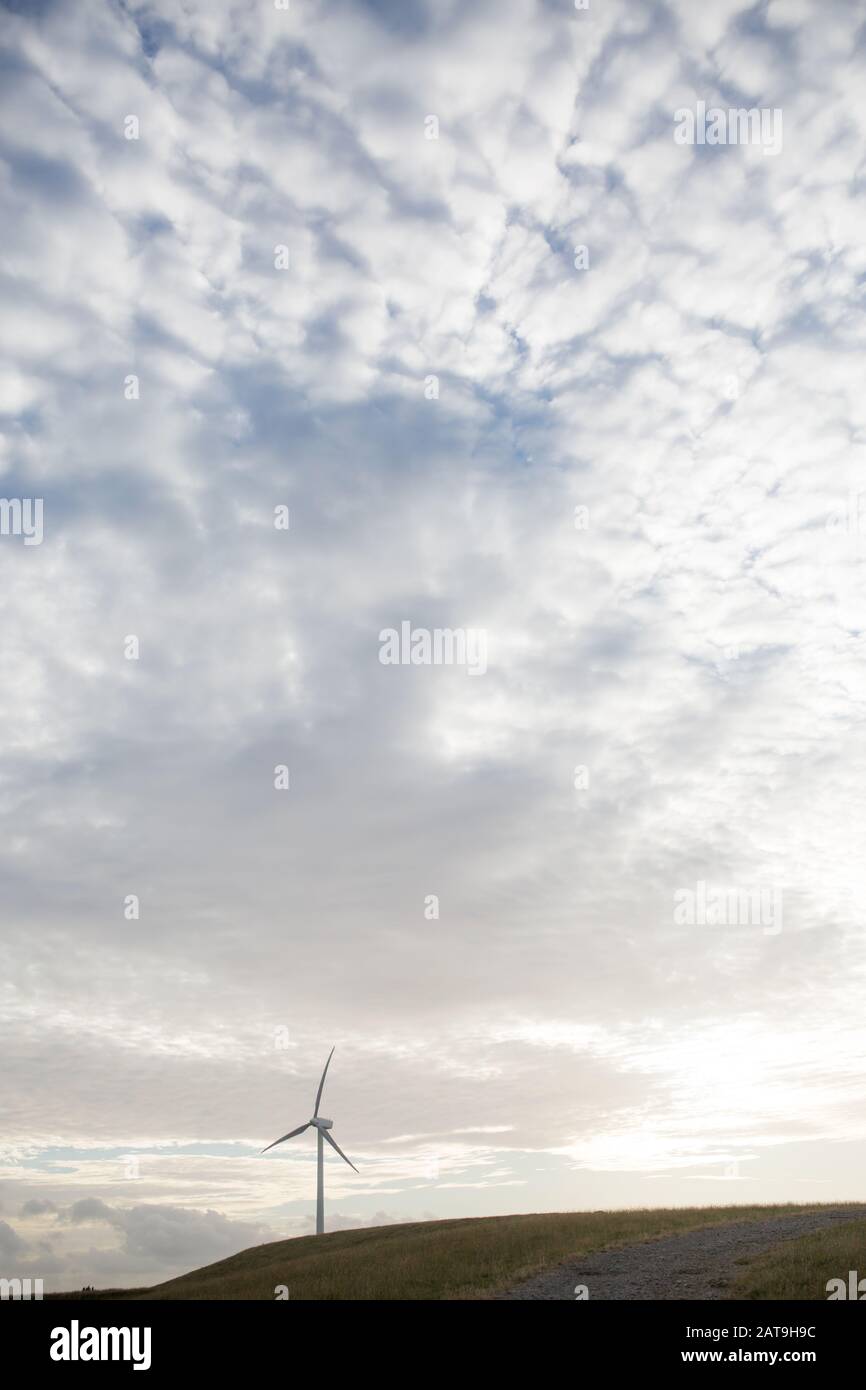 wind turbine used for renewable  energy production on a hill in the country with sun setting behind, located in Toora Victoria Australia Stock Photo