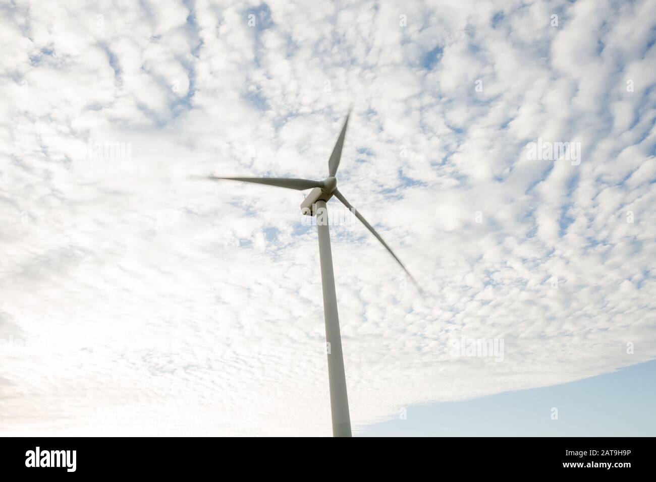 wind turbine used for renewable energy production with motion blur and clouds behind, located in Toora Victoria Australia Stock Photo