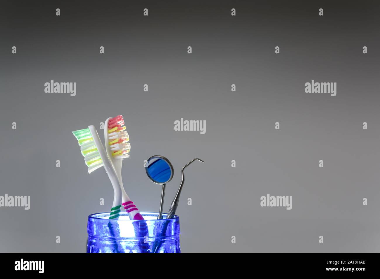 Toothbrushes and dentist set isolated on gray background. Stock Photo