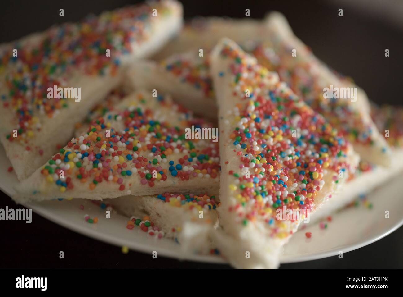 a Close up plate of fairy bread, Australian party food bread buttered and then sprinkled with sprinkles Stock Photo