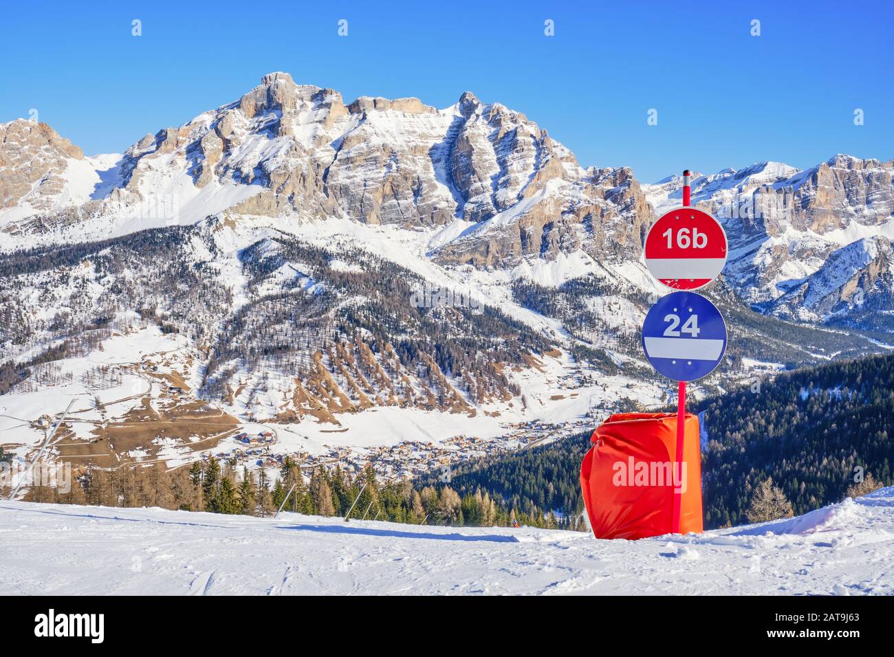 Winter view of Piz dles Cunturines (Cima Cunturines) from a ski slope in Alta Badia, South Tyrol, Dolomiti mountains, Italy, with piste signs for red Stock Photo