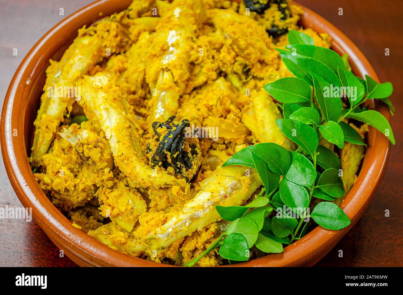 Kerala style fish curry with coconut garnished with fresh green curry leaves Stock Photo