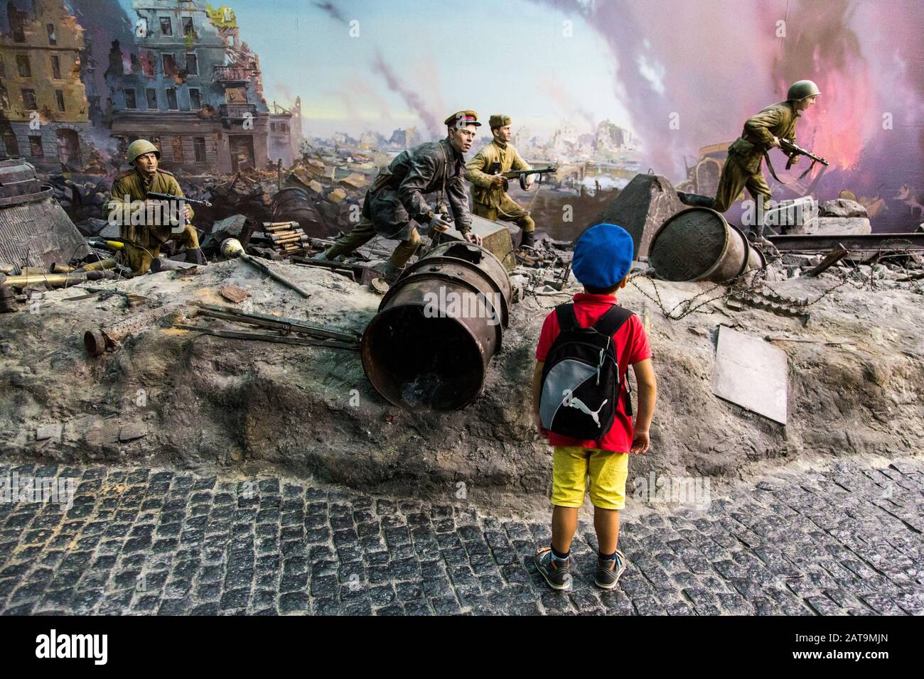 Kid waching a World War II exhibition inside Victory Museum or Great Patriotic War Stock Photo