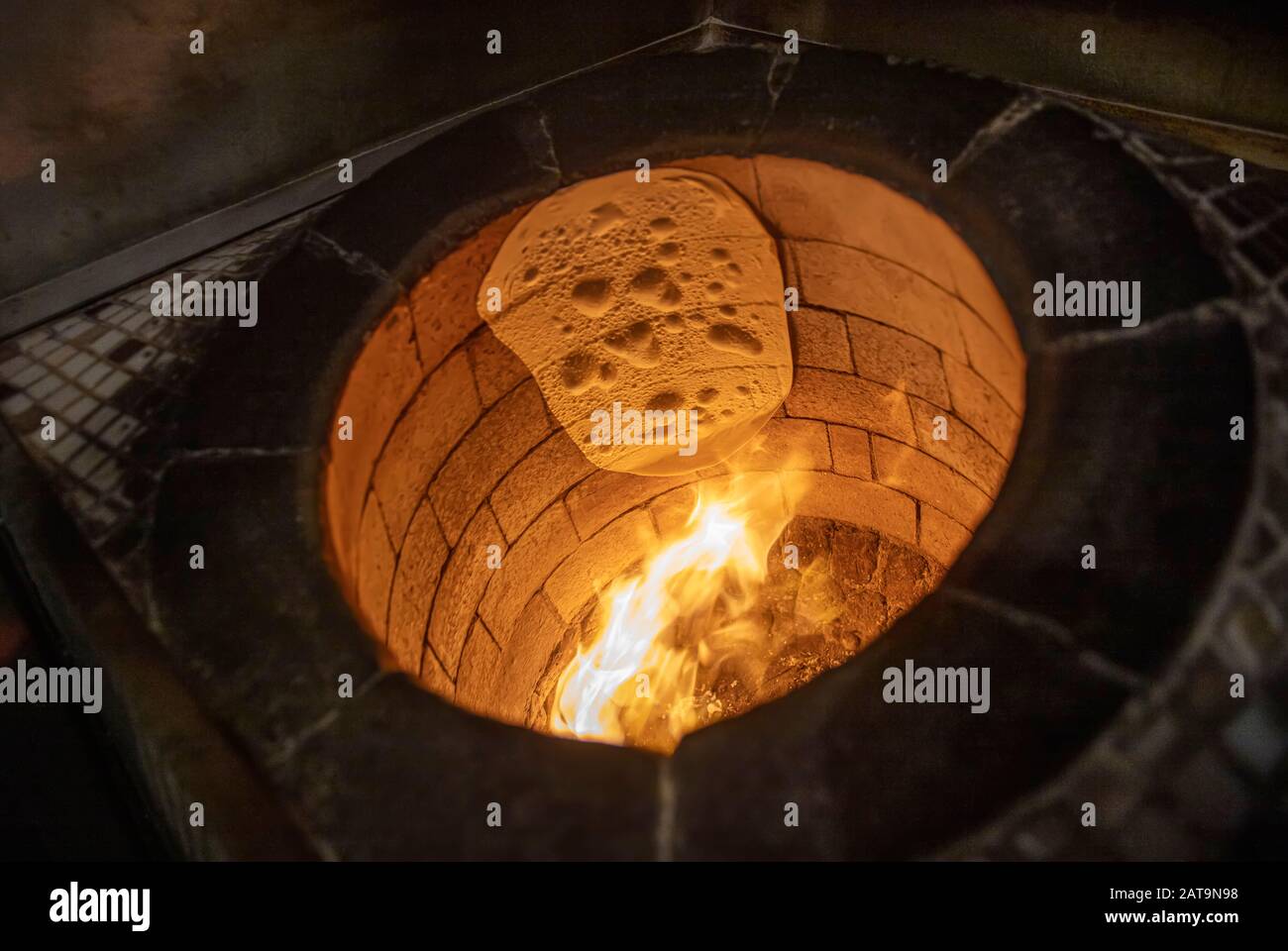 Traditional turkish wood fired stone brick oven. This stone oven for Turkish pide or pita bread. Also known as Tandır or Tandir. Stock Photo