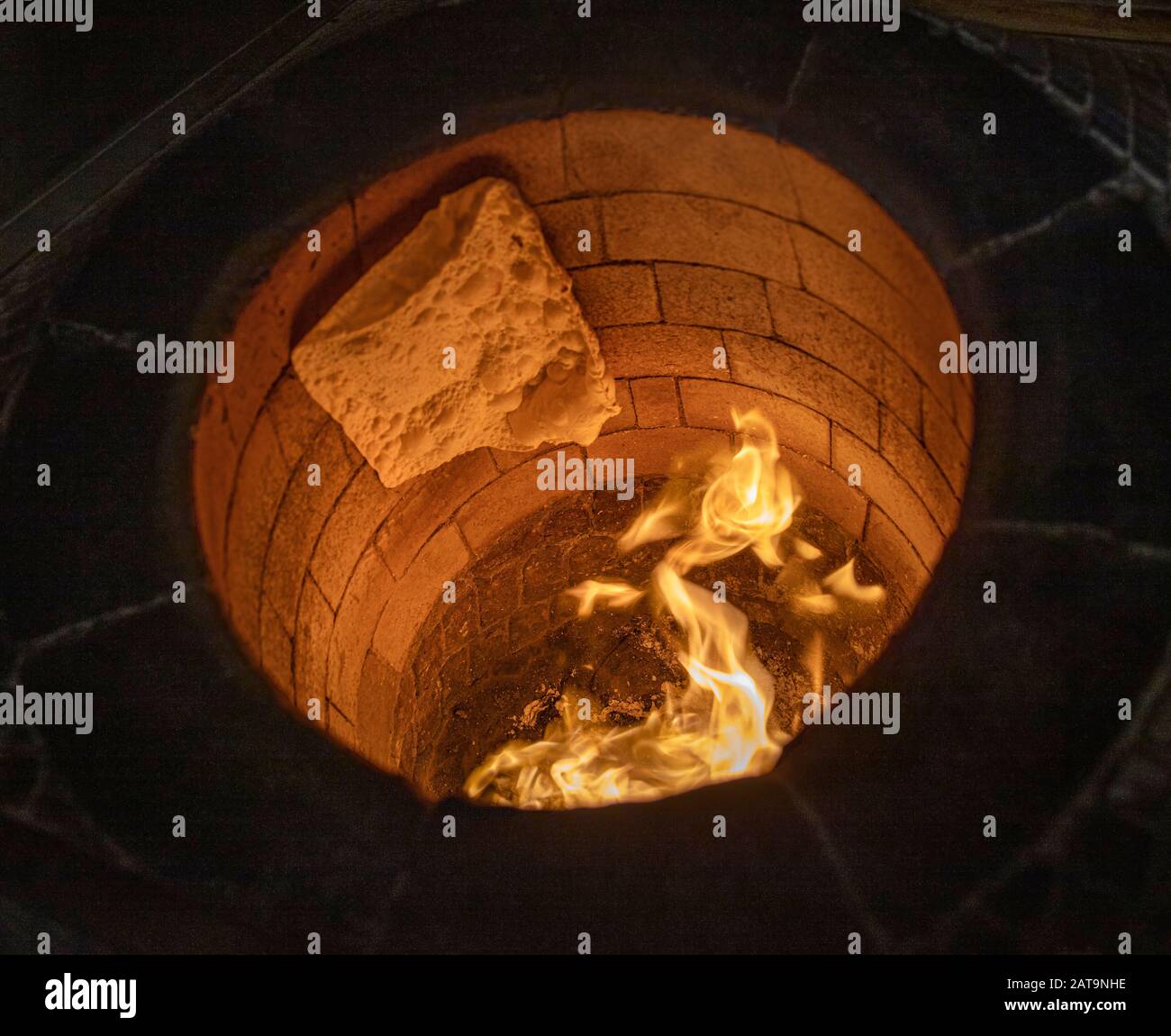 Traditional turkish wood fired stone brick oven and pita or pide bread  dough. This stone oven for Turkish pide or pita bread. Also known as Tandir  Stock Photo - Alamy