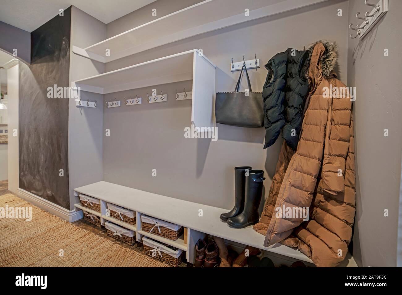 Walk in closet with clothes bag and shoes on the built in shelves and hangers Stock Photo