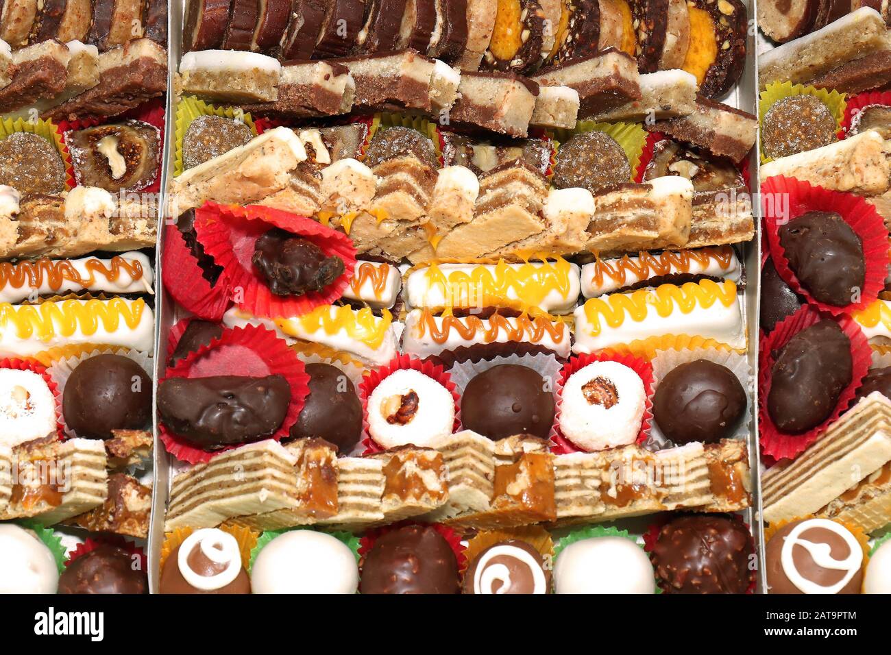Colorful sugary sweets and cake pieces pile background Stock Photo Alamy