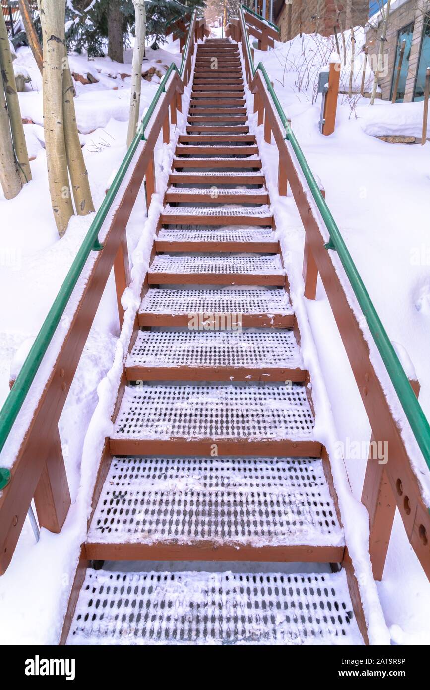 Snowy outdoor stairs against snow covered ground in Park City Utah in winter Stock Photo