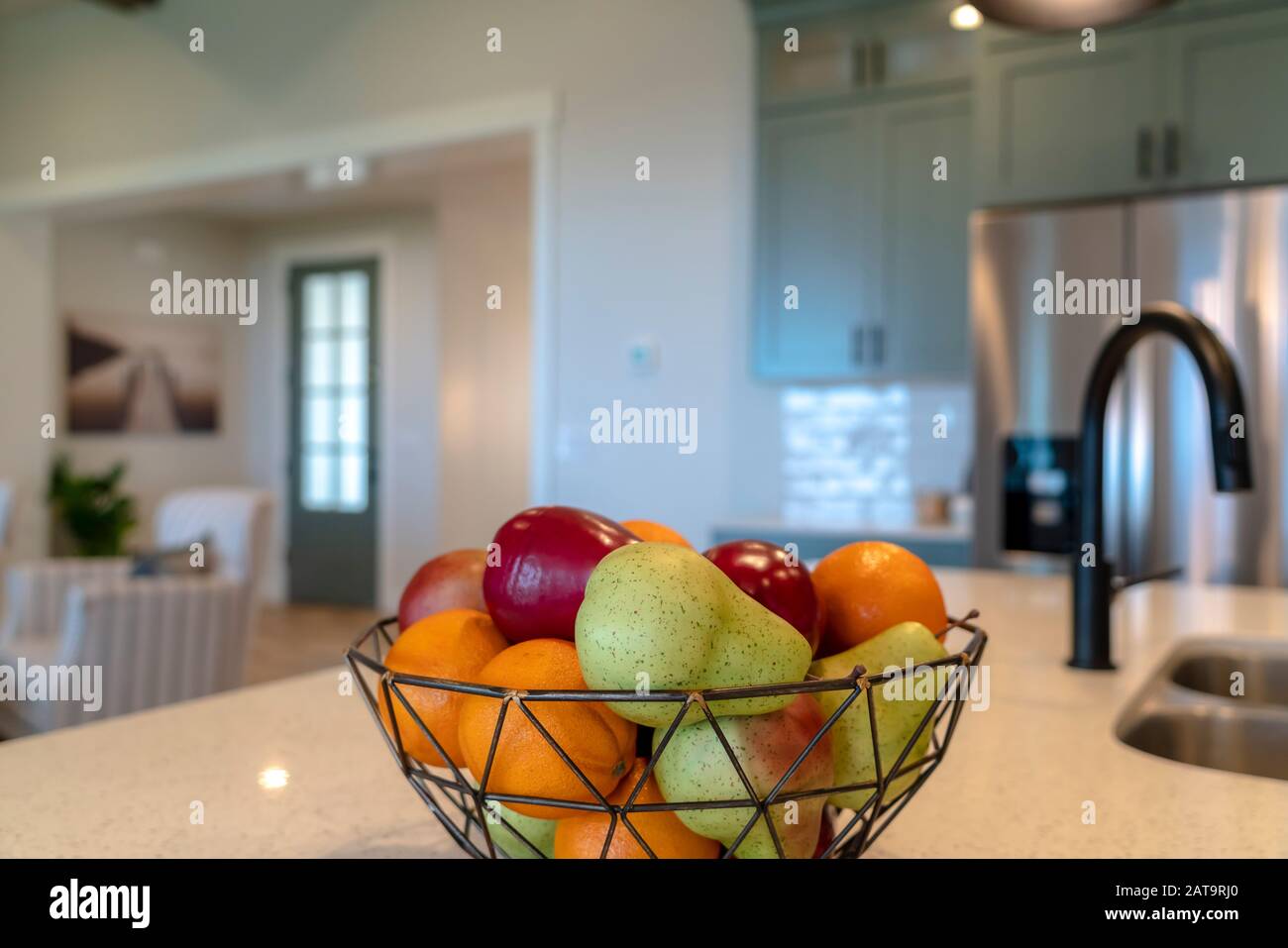Fruit Basket On A Kitchen Island With Black Faucet And Double Basin Sink Stock Photo Alamy