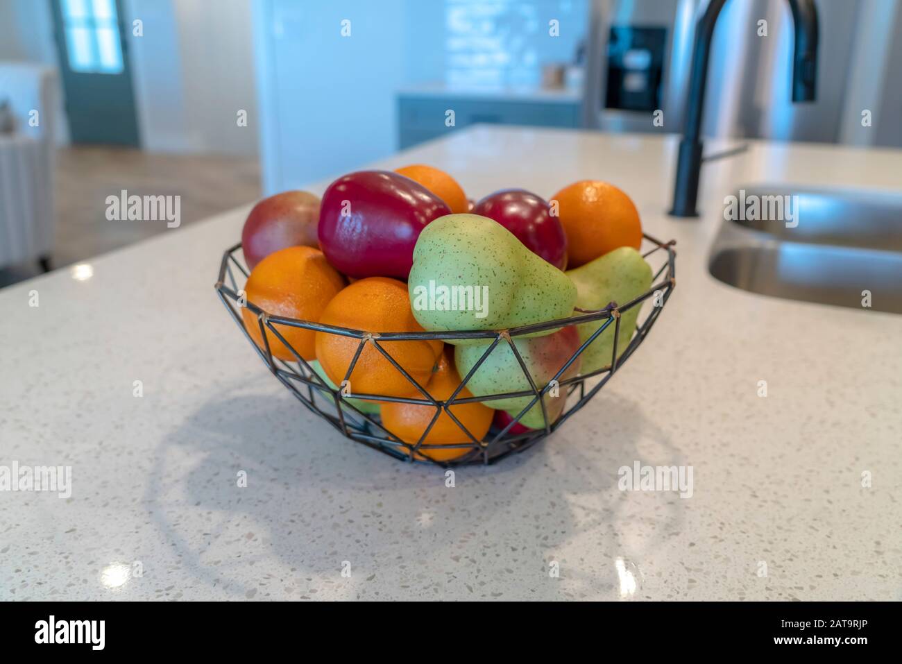 Wire Geometric Basket With Fresh Fruits Against Kitchen Island Faucet And Sink Stock Photo Alamy