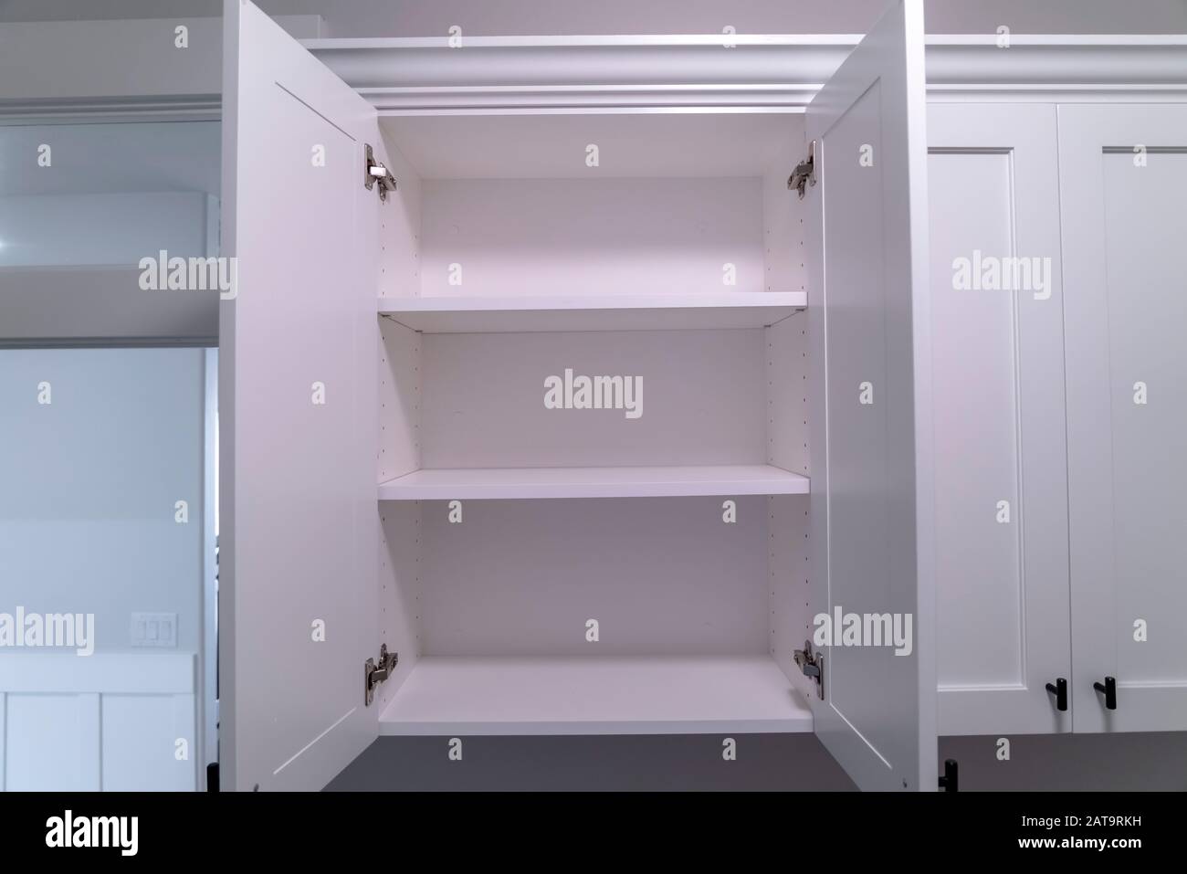 Hanging wall with open doors and shelves at a new home