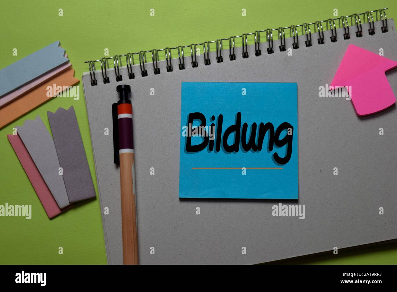 Bildung write on a sticky note isolated on office desk. German Language