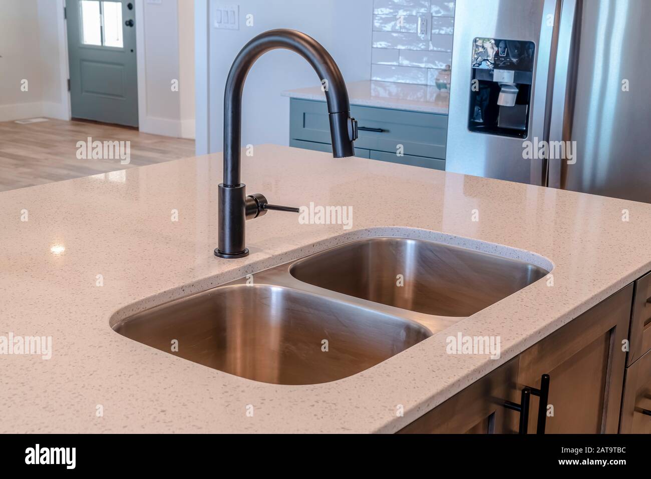 Black Faucet And Stainless Steel Double Basin Sink On Kitchen